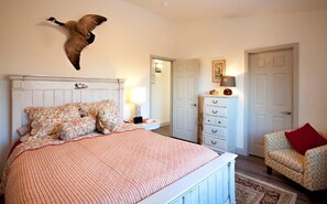 Main bedroom with queen sized bed and walk in closet
