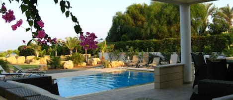 Seated patio beside private pool