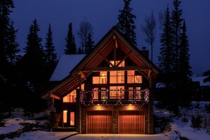 Night view of the large front deck and windows. 