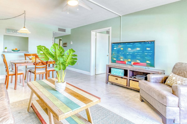 Relax in a bright and beachy living space with a cozy dining area