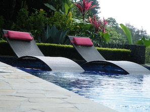 Tan or read a book in these priceless loungers in the mirror section of pool 