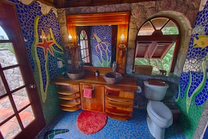 Master bath colorfully defined by aquatic murals made by local artists we know.