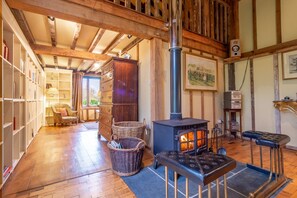 Rose Barn, Stoke By Nayland: A wood burning stove adds warmth and ambient light to the open plan living area