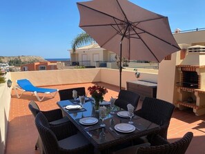 View of the terrace with for sunbathing and alfresco dining with a sea view.