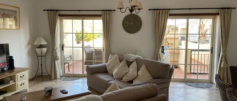 The living area with views of the terrace through sliding doors.