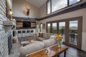 Top Of The World Great Room with Fireplace, Bar, HD Smart TV, and Huge Wall of Windows which frame Mountain Views