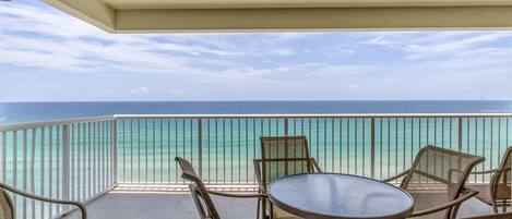 Balcony with table and chairs and a beautiful view of the gulf.
