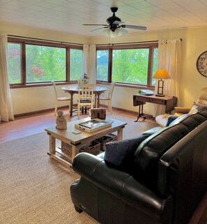 Dining table for four, large windows overlooking the lake