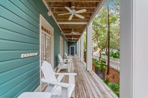 SPACIOUS FRONT PORCH WITH ADIRONDACK CHAIRS