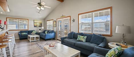 Decorated living area with nautical decor. Two sofa sleepers & two loveseats