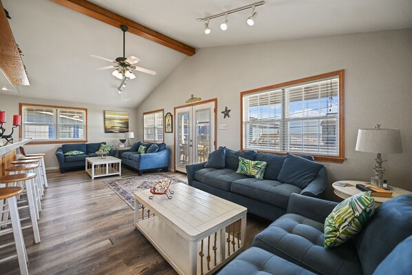 Decorated living area with nautical decor. Two sofa sleepers & two loveseats