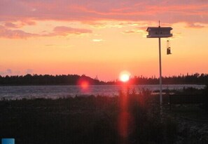 View of sunset from across the road from cottage