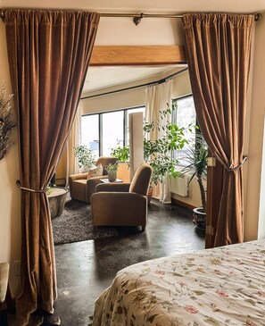 One of the bedroom has French doors into living area, framed by velvet curtains