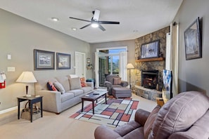 Main Living Room with Comfy Seating, Fireplace, Deck Access, and Large TV