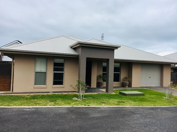 Front of Villa with private, undercover, lock up garage. 