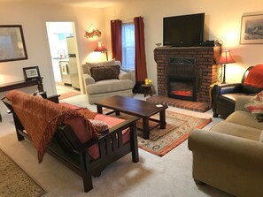Cozy living room with electric fireplace. 