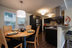 Dinning area with table and four chairs open to living room