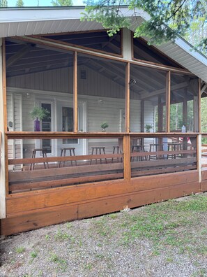 Screen porch side of Cottage by the fire pit