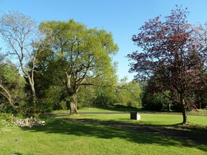 The Kist looks out over tree and lawns with the Campsie Fells in the background