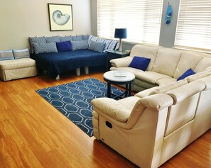 leather sectional with recliners and daybed in living space end of great room   