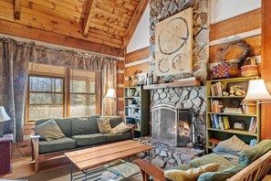 Living Room Features Vaulted Ceilings and a Floor to Ceiling Stone Fireplace