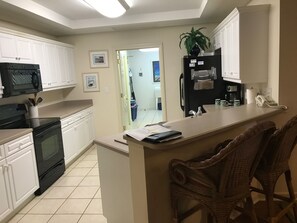 Fully equipped kitchen with new refrigerator, dishwasher, and stove.