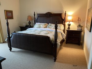 Master bedroom has a king bed, night tables, a large dresser, and a Smart TV.