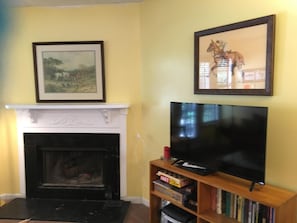 living room with burn burning fireplace and flat screen TV
