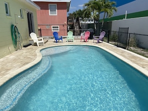 Heated pool with sun shelf and extra long bench for seating