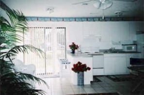 Kitchen with sliding door to patio with pool view