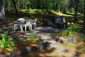 Stone patio and barbeque with river view