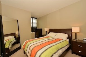 Master bedroom has a dresser and two side tables, and high quality sheets and duvet
