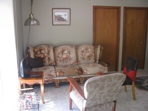 The living room is equipped with a TV/DVD combo unit.
