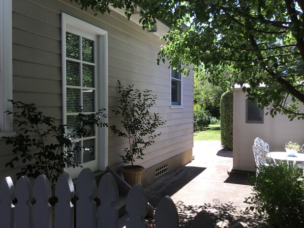 Leafy side entrance—access past carport