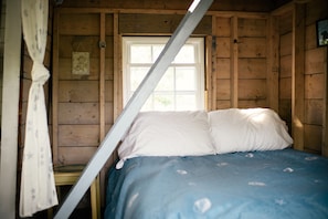 Full size bed and ladder to the loft