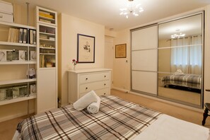 Bedroom: double bed; chest of drawers; door to living room; cupboards