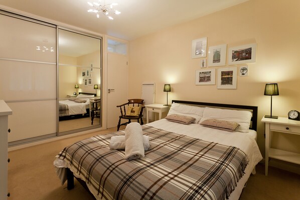 Bedroom: cupboards, door to bathroom, double bed