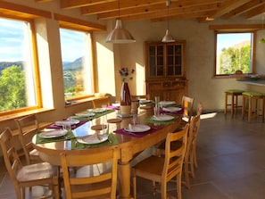 Dining space with large table for 12 to 14 guests and magnificent sunset views 