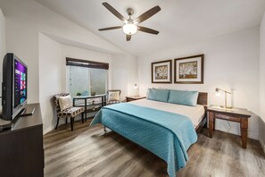 Master bedroom with king bed with Smart Roku TV. To the right is a attached bath