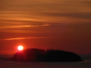 Enjoy coffee while watching the sunrise from the deck of Harbor View Cottage