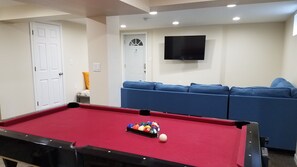 Basement pool table, couch, tv