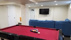 Basement pool table, couch, tv
