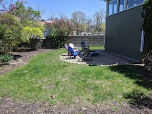 Side yard with fire pit and chairs