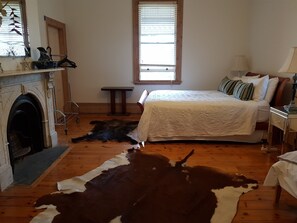 Bedroom 3 .A queen bed with a marble fireplace .