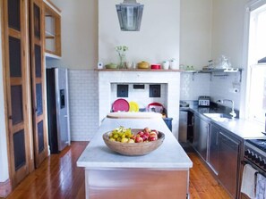 The kitchen is  well equipped with all appliances and a large island bench .