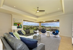 Living room extends out to upper lanai with ocean views