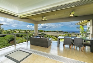 Living room extends out to upper lanai with ocean views