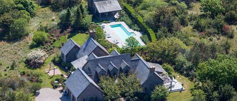 A view of the house and pool house from above.