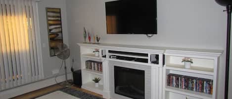 Living Room with Built in Fireplace,Book Shelf and 55" Smart Samsung TV