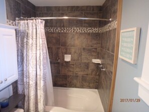 Tiled shower and tub.